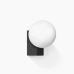 Geometric globe wall sconce with matte black bracket and frosted white glass sphere - minimalist modern lighting design close-up