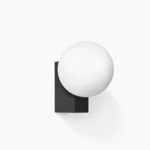Geometric globe wall sconce with matte black bracket and frosted white glass sphere - minimalist modern lighting design close-up
