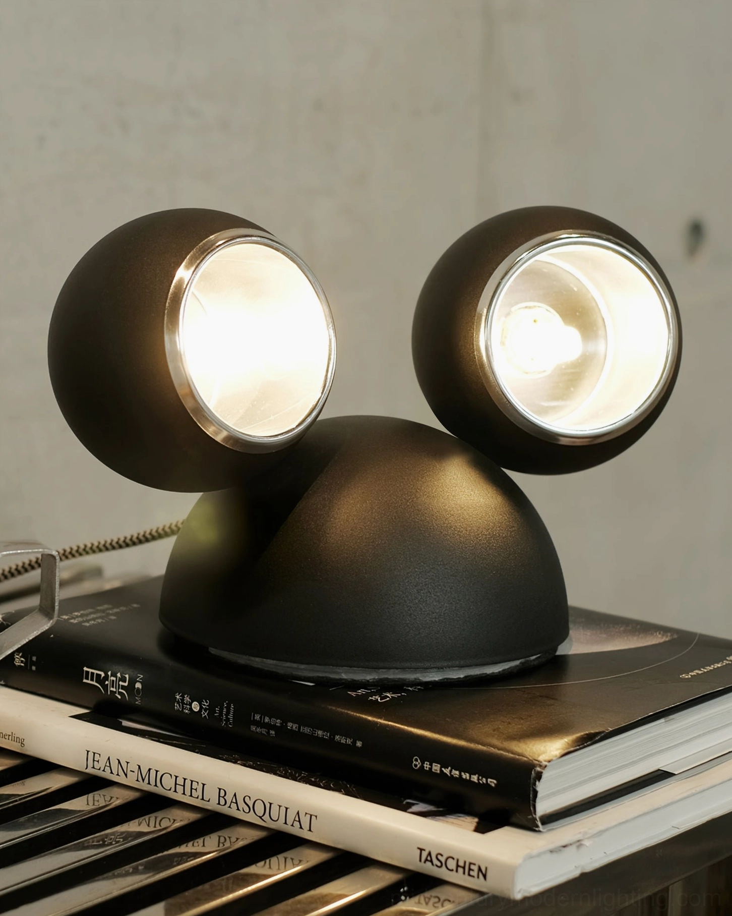 Lit matte black Mickey table lamp warm ambient light glowing spherical design with ear silhouette
