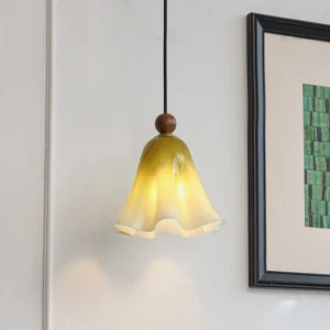 Green yellow gradient Meblo pendant light hanging in contemporary home with framed wall art and warm ambient lighting