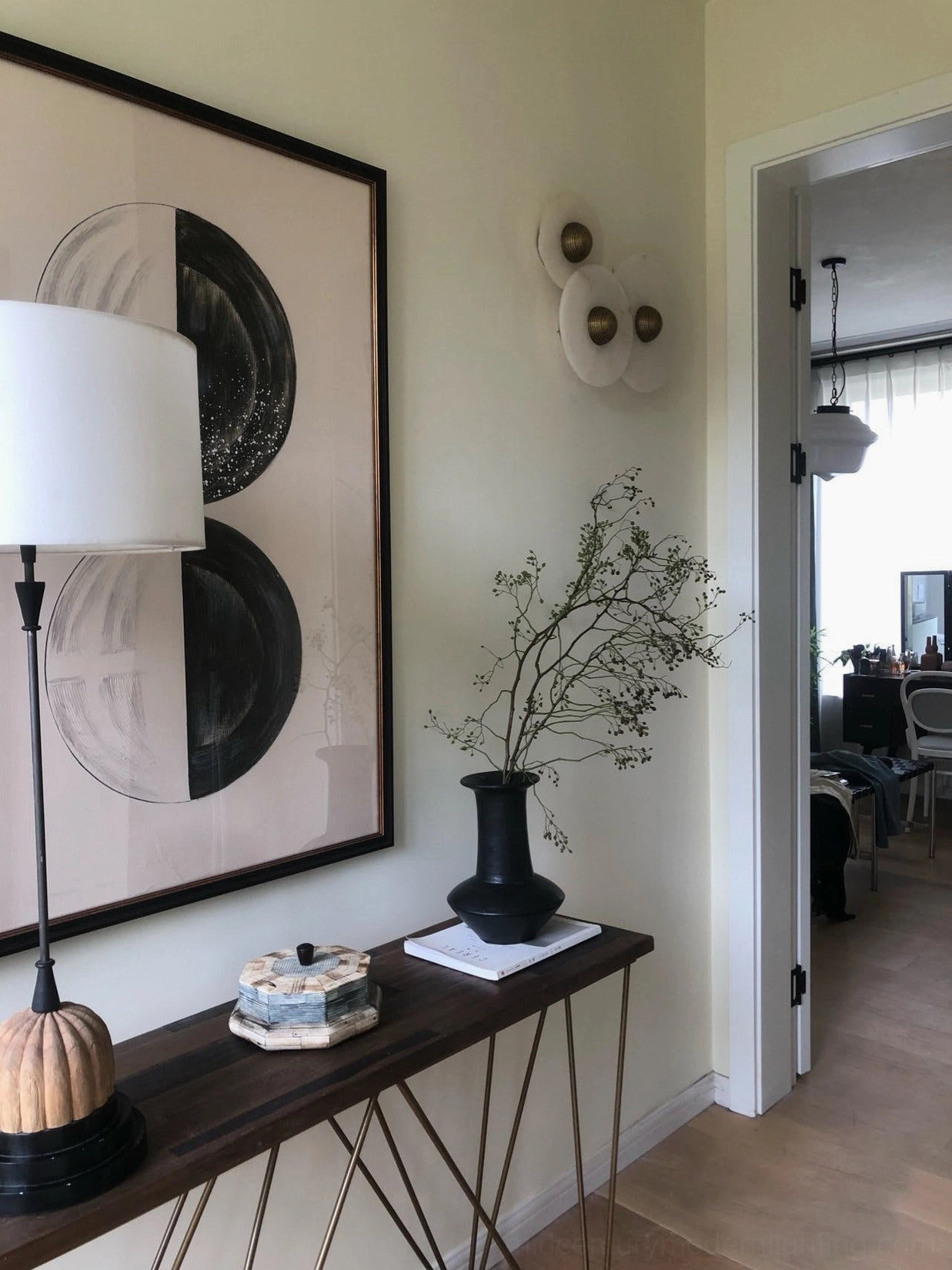Alabaster wall light with bronze metal finish frame, natural stone disc, architectural integration