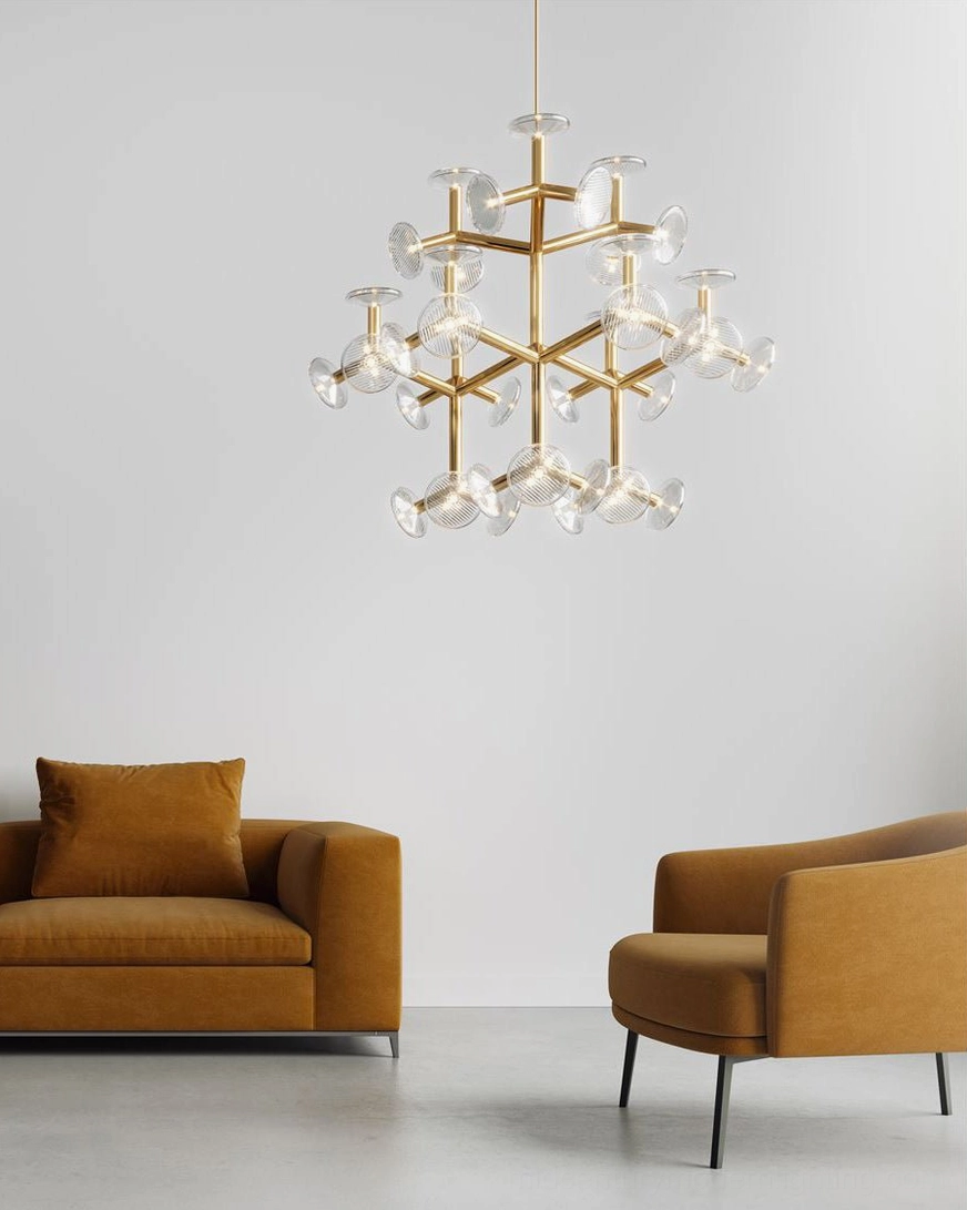 Medium brass snowflake chandelier hanging in modern minimalist living room interior