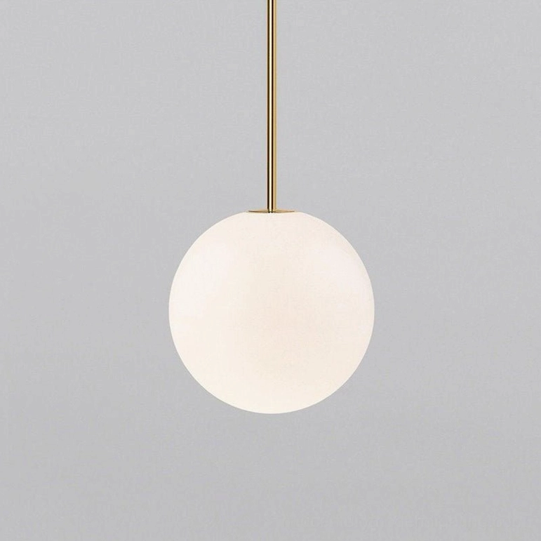 Medium brass globe pendant 25cm creating balanced sculptural presence in dining space