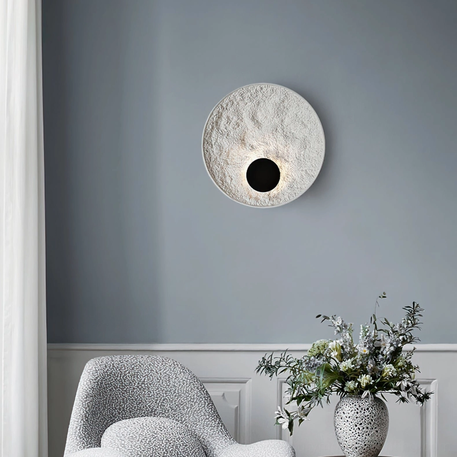 Melesa modern wall sconce compact size textured resin circular fixture close-up detail view