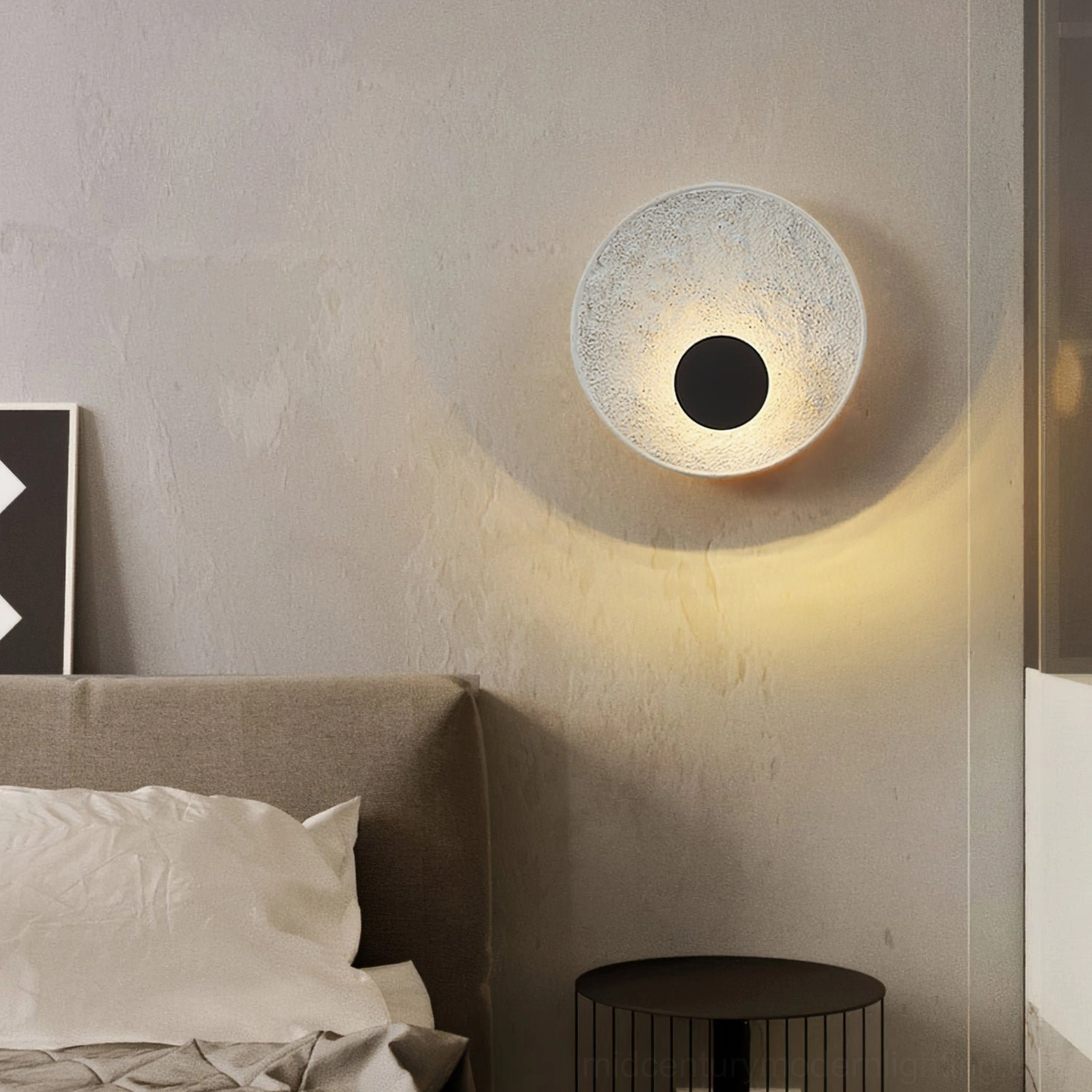 Melesa round wall sconce bedroom mounted above light brown fabric headboard with metal side table