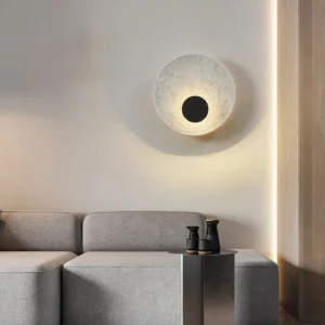 Melesa modern wall sconce installed in contemporary living room with warm backlight and matte black center detail