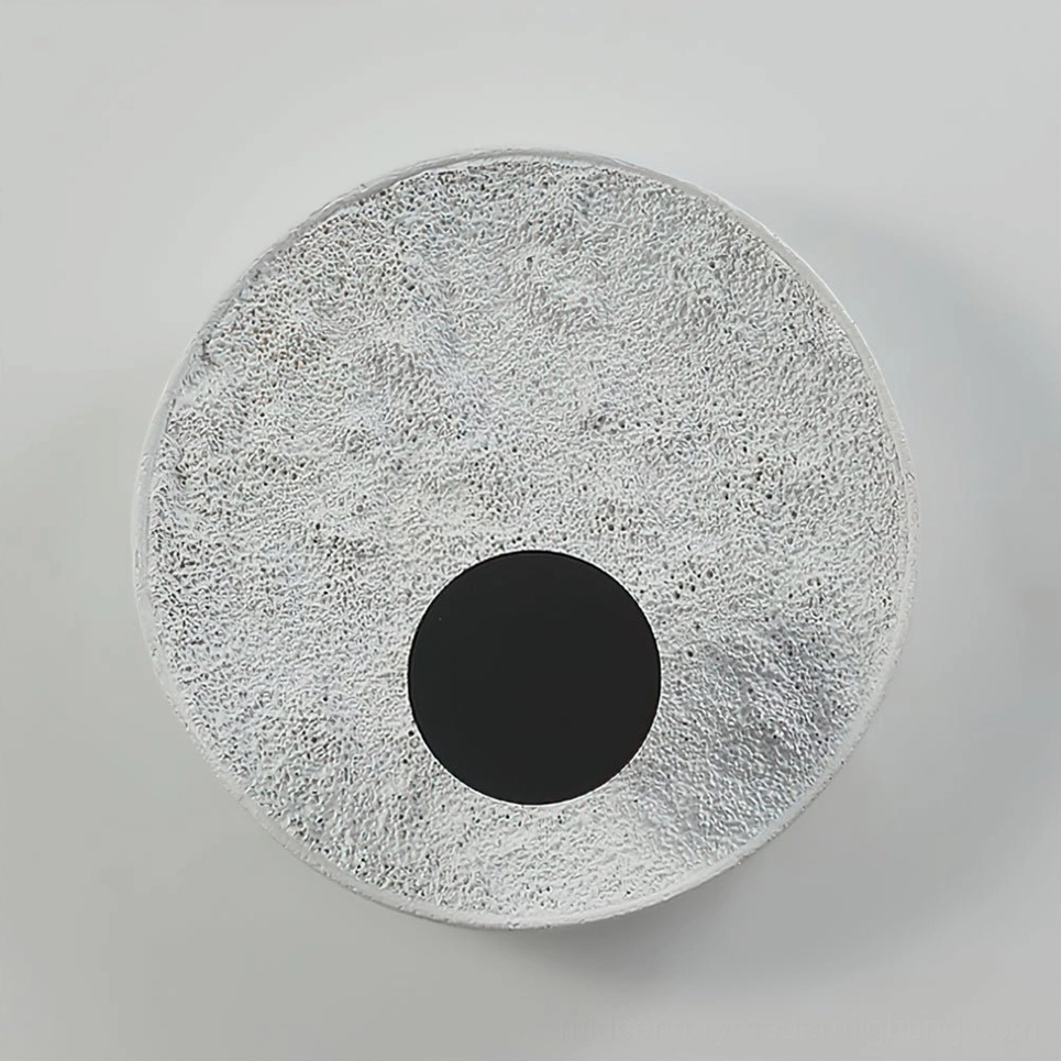 Melesa textured wall sconce available in white and black finishes warm and cool light options