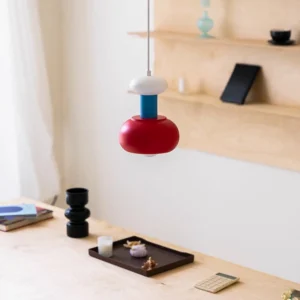 Meli modern pendant lamp styled in home office with blue white red color-blocked design above desk workspace