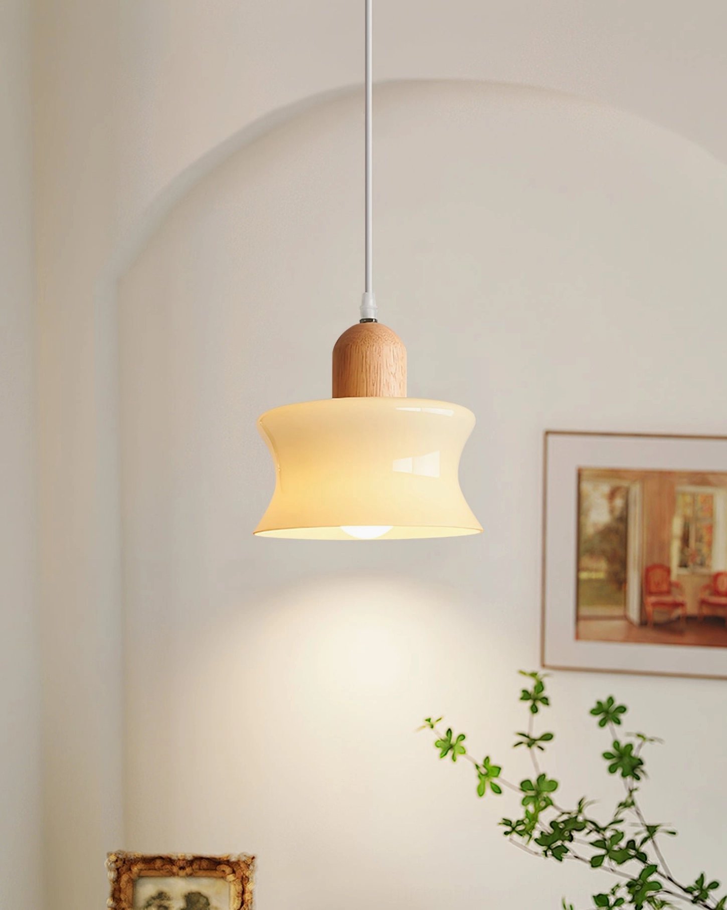 Mellow cream glass pendant lamp installed in warm modern bedroom with arched wall, creating soft ambient lighting