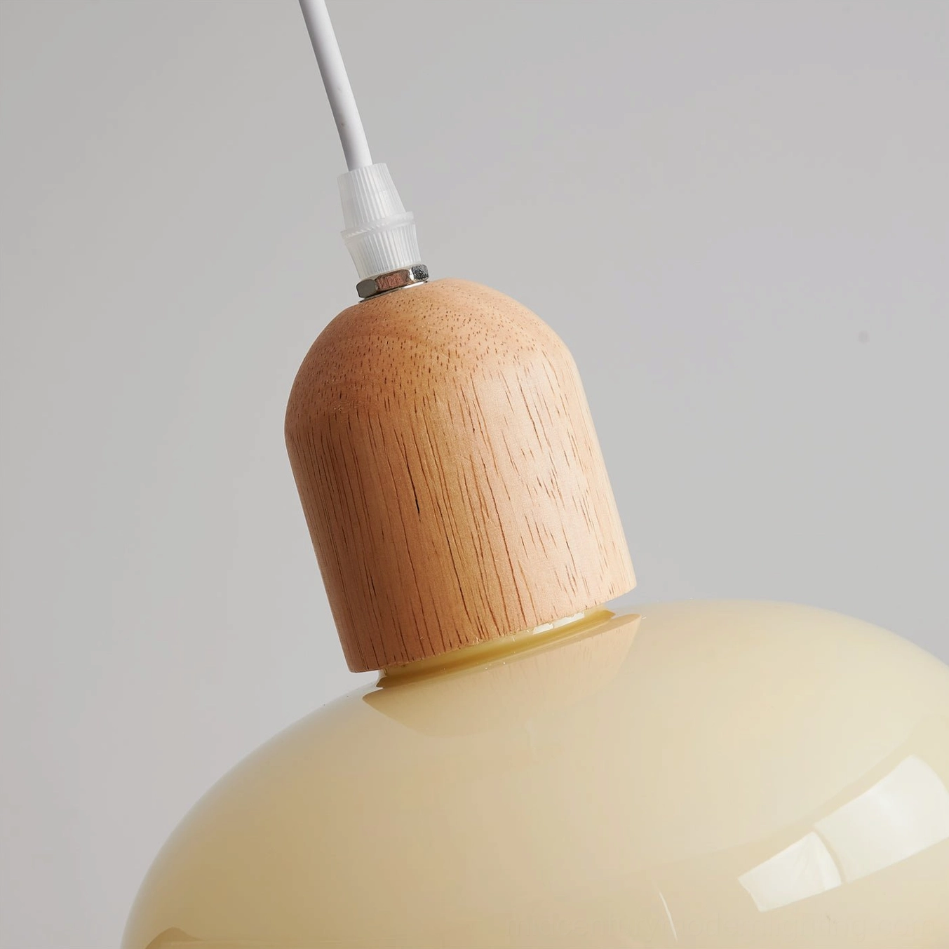 Mellow handcrafted pendant light in Scandinavian minimal interior, warm ambient glow creating inviting home atmosphere