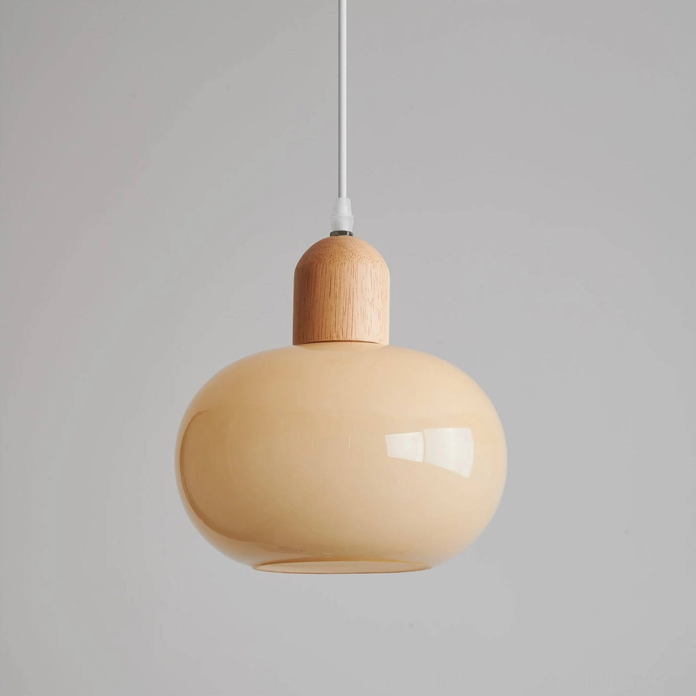 Multiple mellow glass pendant lamps at varying heights in contemporary living space, layered lighting application