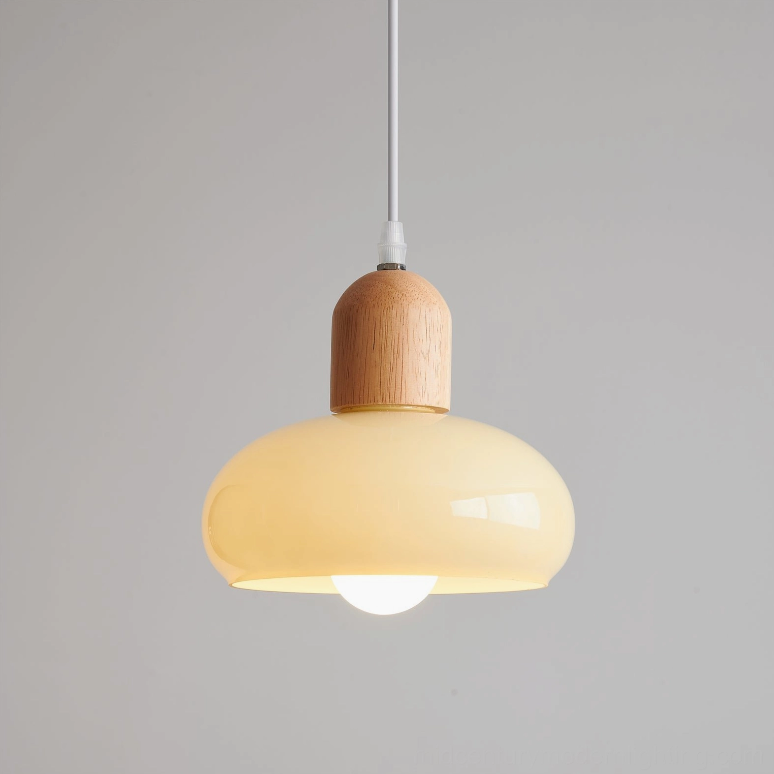 Mellow glass pendant Model B medium size in wood color finish, demonstrating versatile proportion for residential lighting