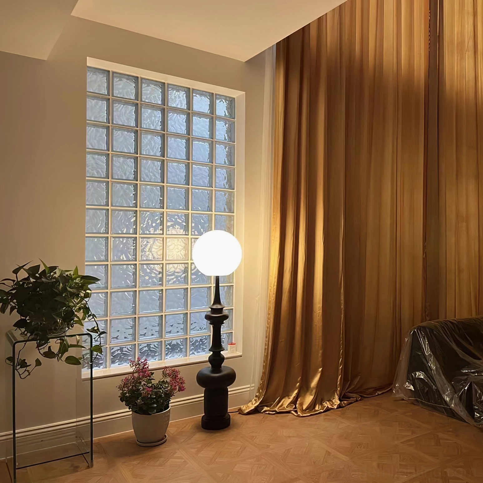 Melrose lit floor lamp glowing shade glass block window bedroom golden curtains potted plants