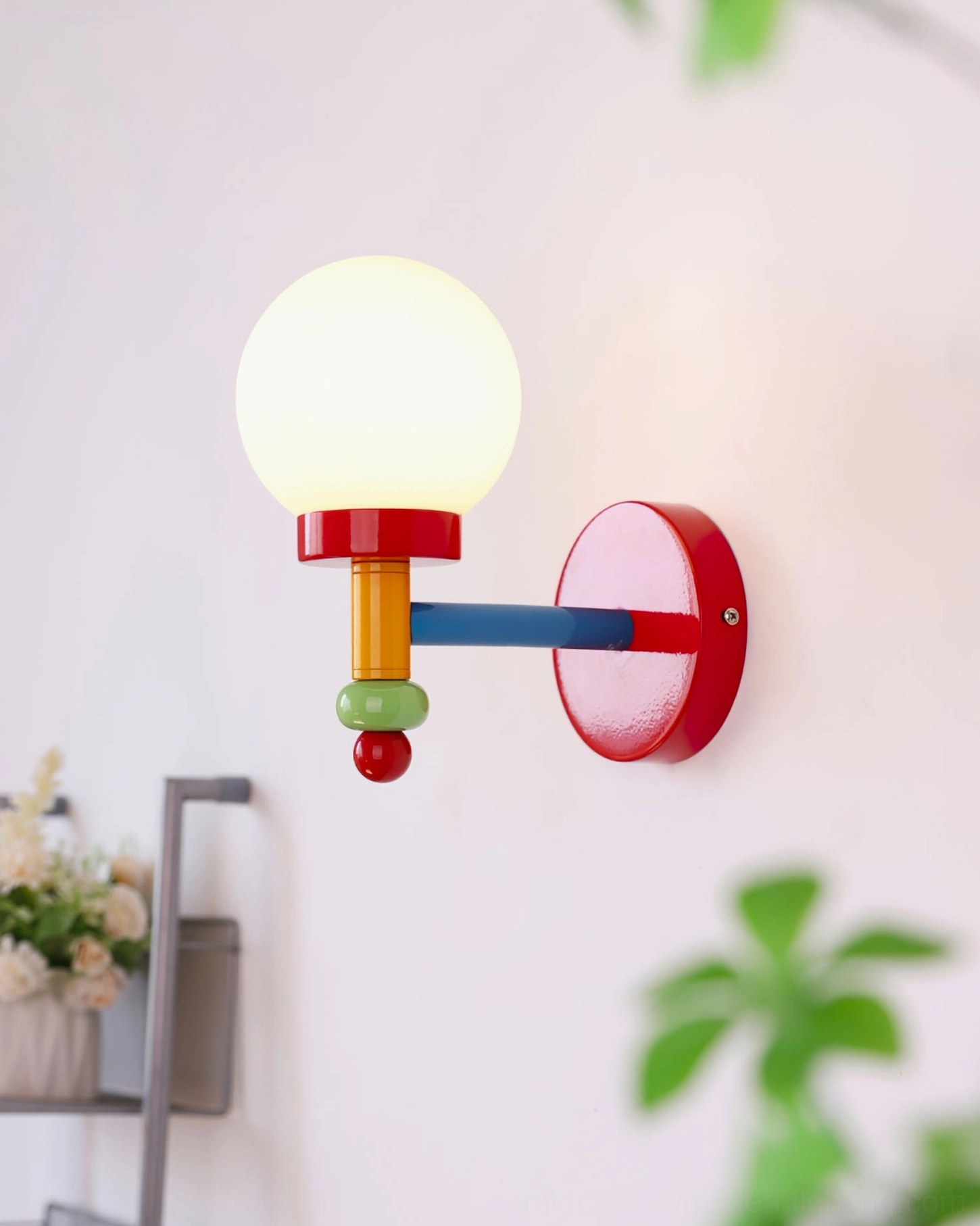 Memphis-style playful wall lamp with geometric color blocking mounted on interior wall with decor