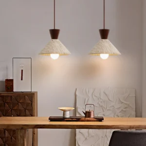 Two Menra pendant lights suspended over modern dining room table with warm ambient lighting japandi style