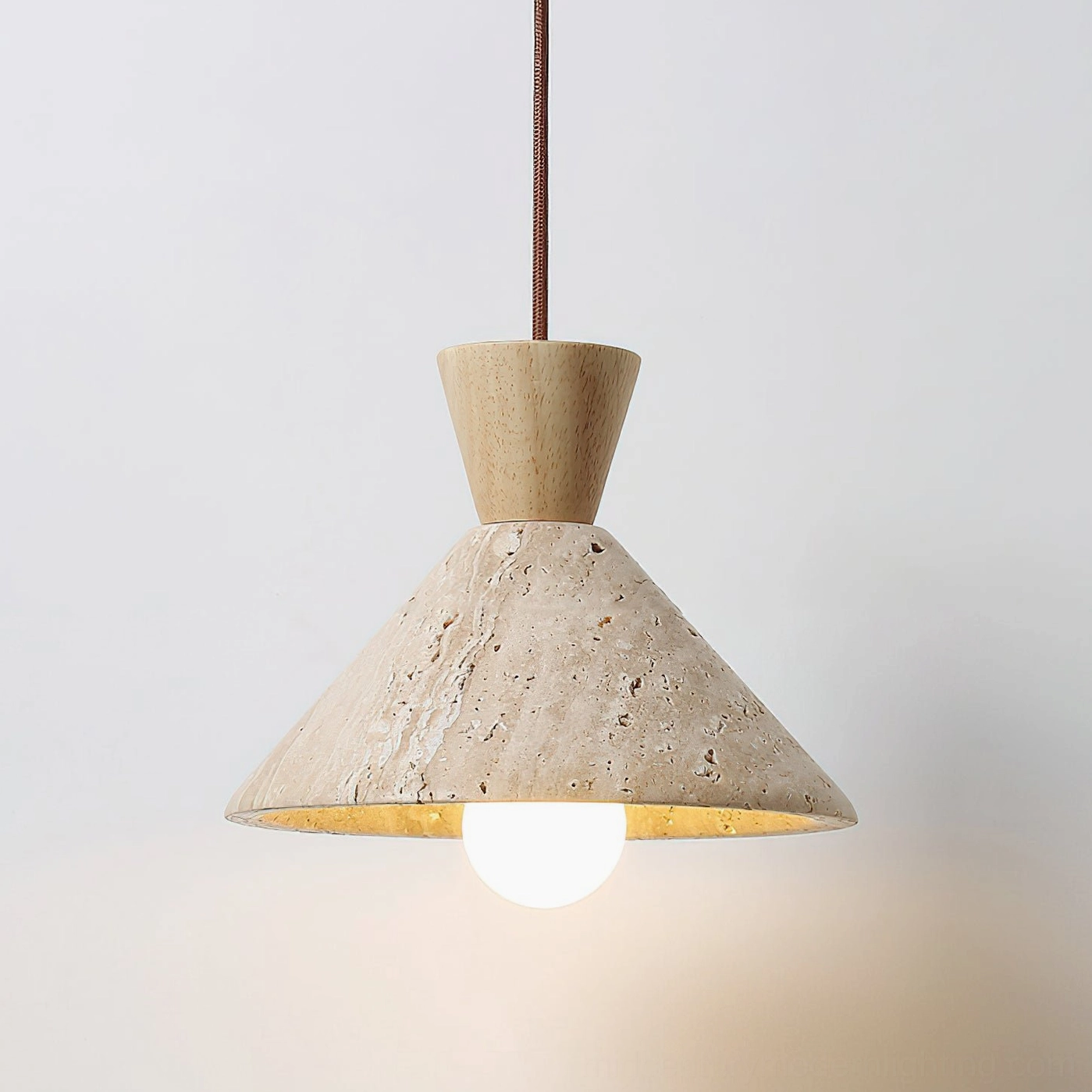 Menra travertine pendant light front view with exposed spherical bulb minimalist pendant fixture