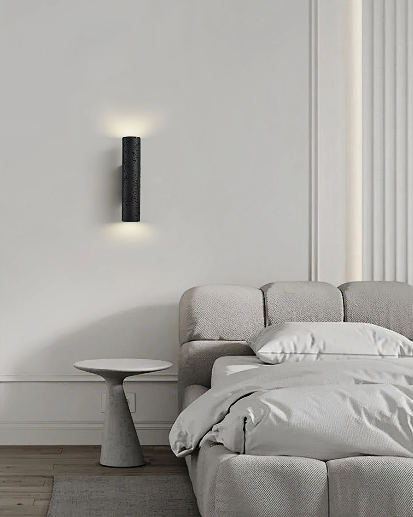 Master bedroom corner perspective showing Meta wall lamp beside upholstered bed with warm soft accent light