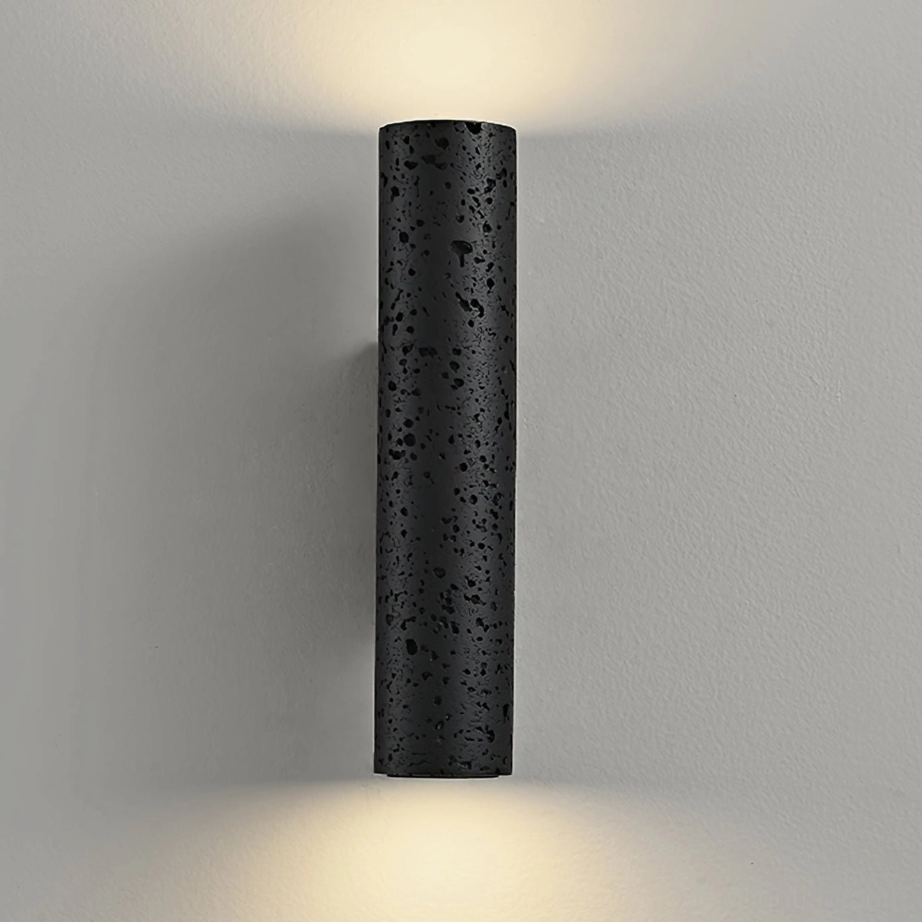 Meta travertine wall lamp beauty shot emphasizing matte black finish and minimalist contemporary design
