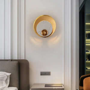 White marble gold wall lamp mounted in minimalist luxury bedroom with soft ambient lighting, side view