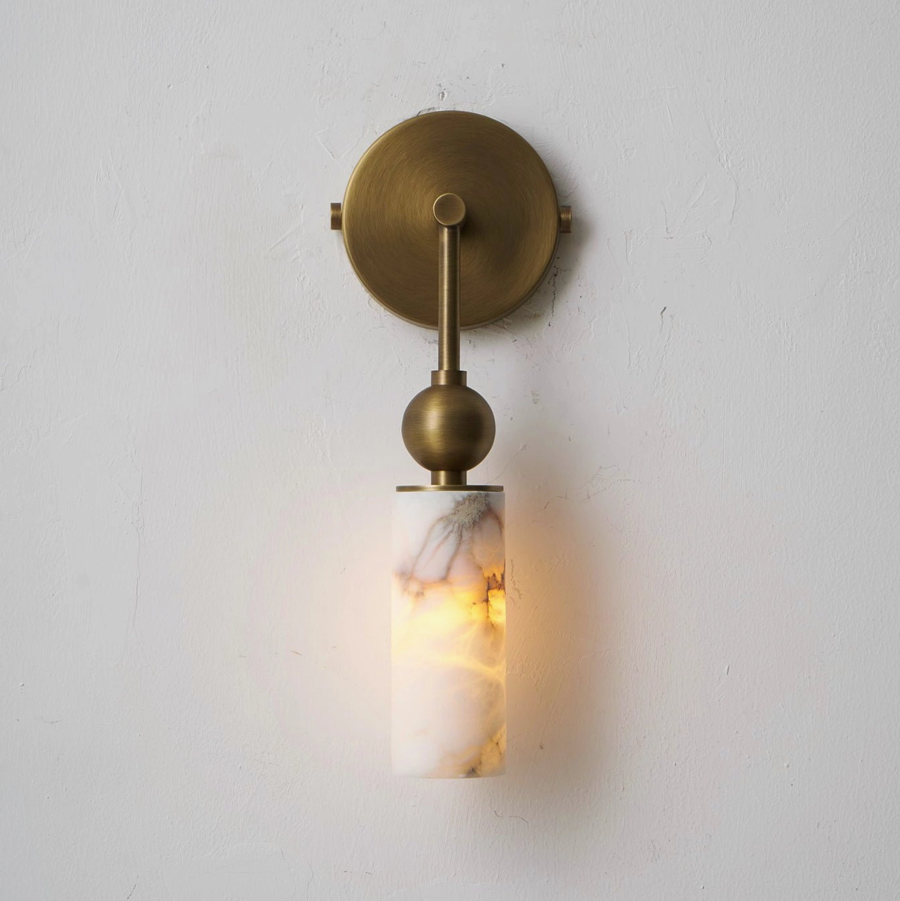 Single-head Metro Alabaster wall lamp mounted in hallway with minimalist modern design aesthetic