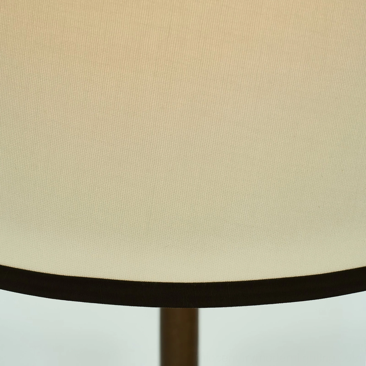 Close-up detail of Mezzo floor lamp shade showing woven off-white fabric and black trim with metal pole