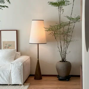 Mezzo mid-century floor lamp styled in modern living room beside white linen sofa with potted plant