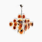 Mid-century modern amber glass disc chandelier with polished nickel frame, frontal studio view