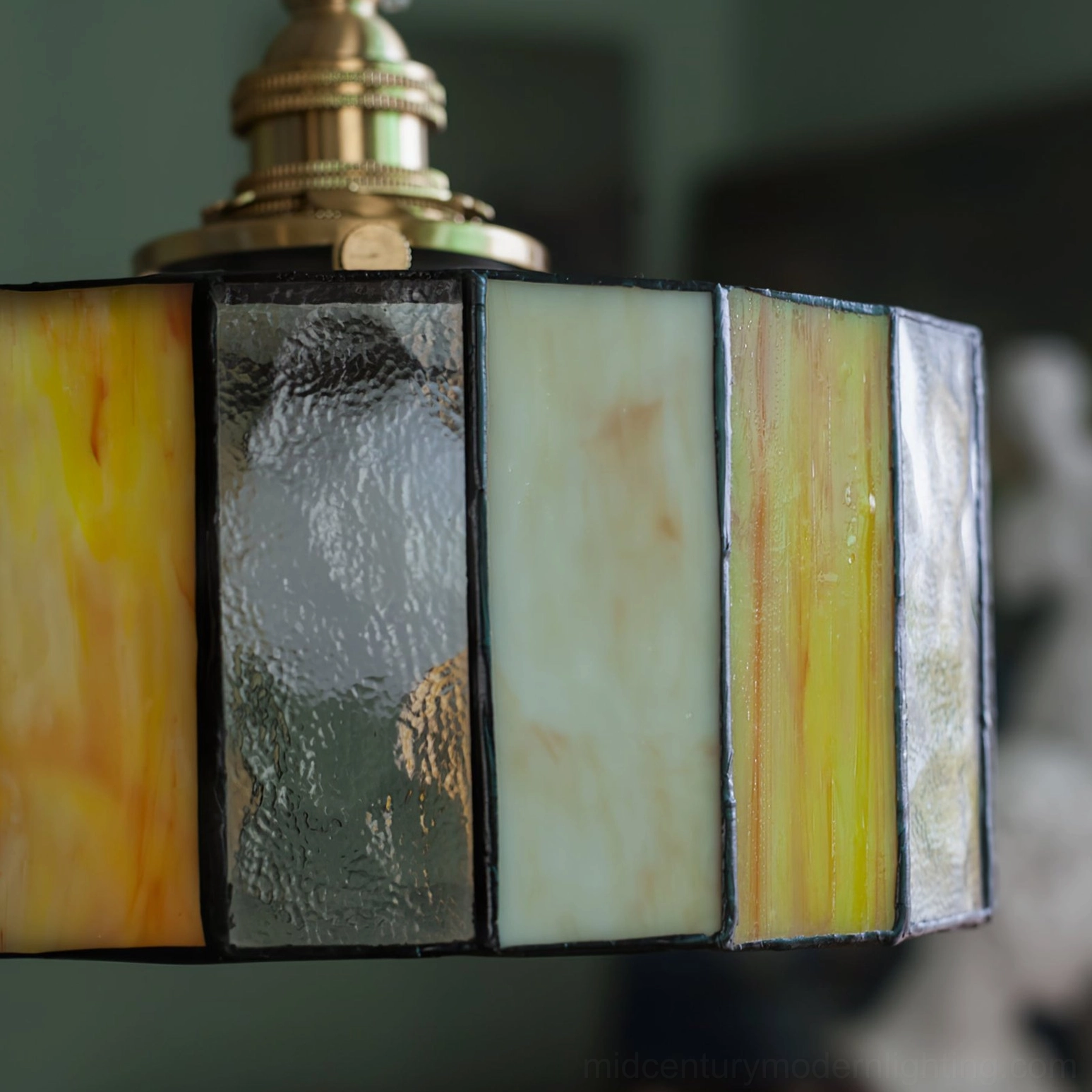 Mid-century modern stained glass drum pendant with warm amber panels and vintage Tiffany-inspired brass hardware