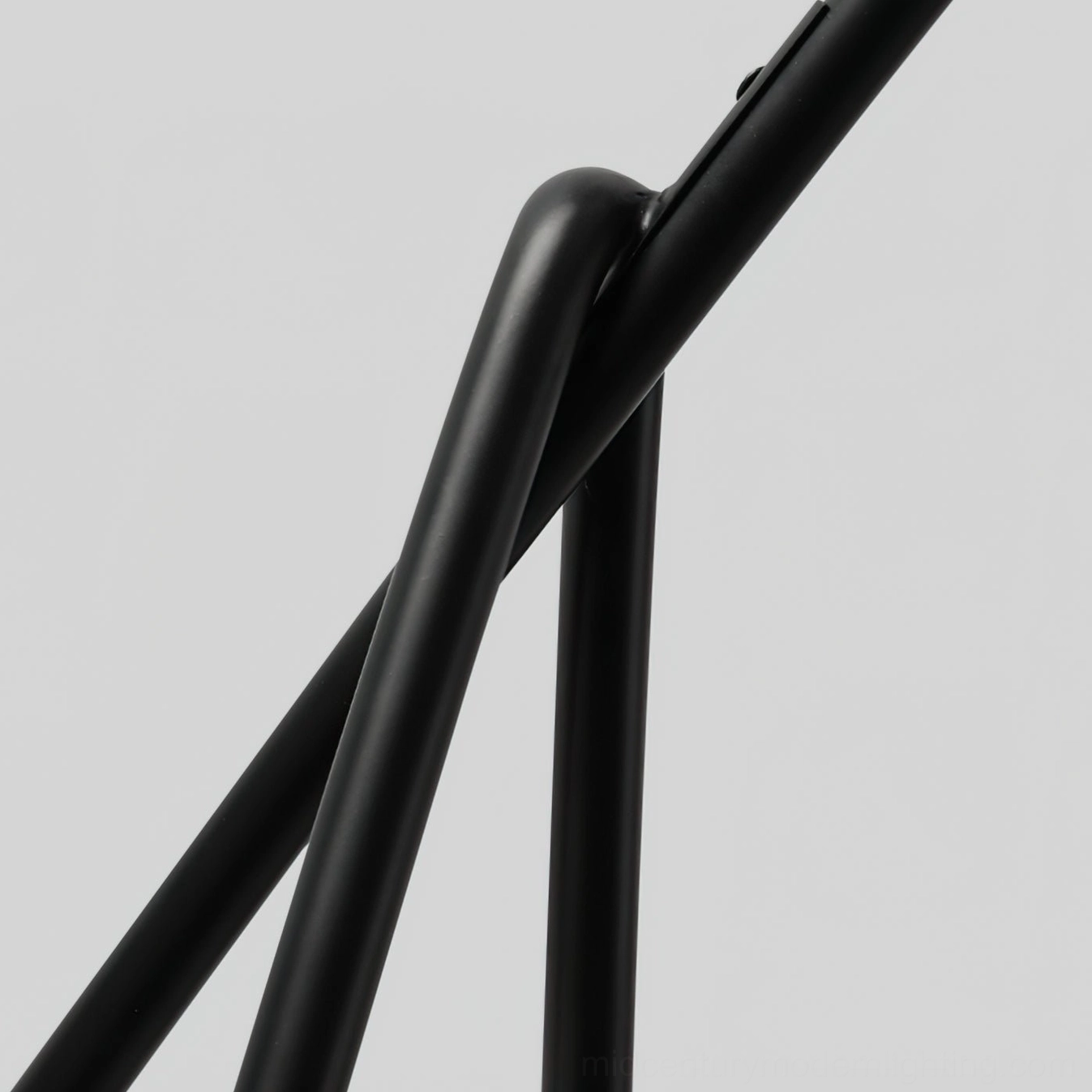 Mid-century modern arc floor lamp with geometric tripod base, close-up detail showing quality construction and metal frame craftsmanship