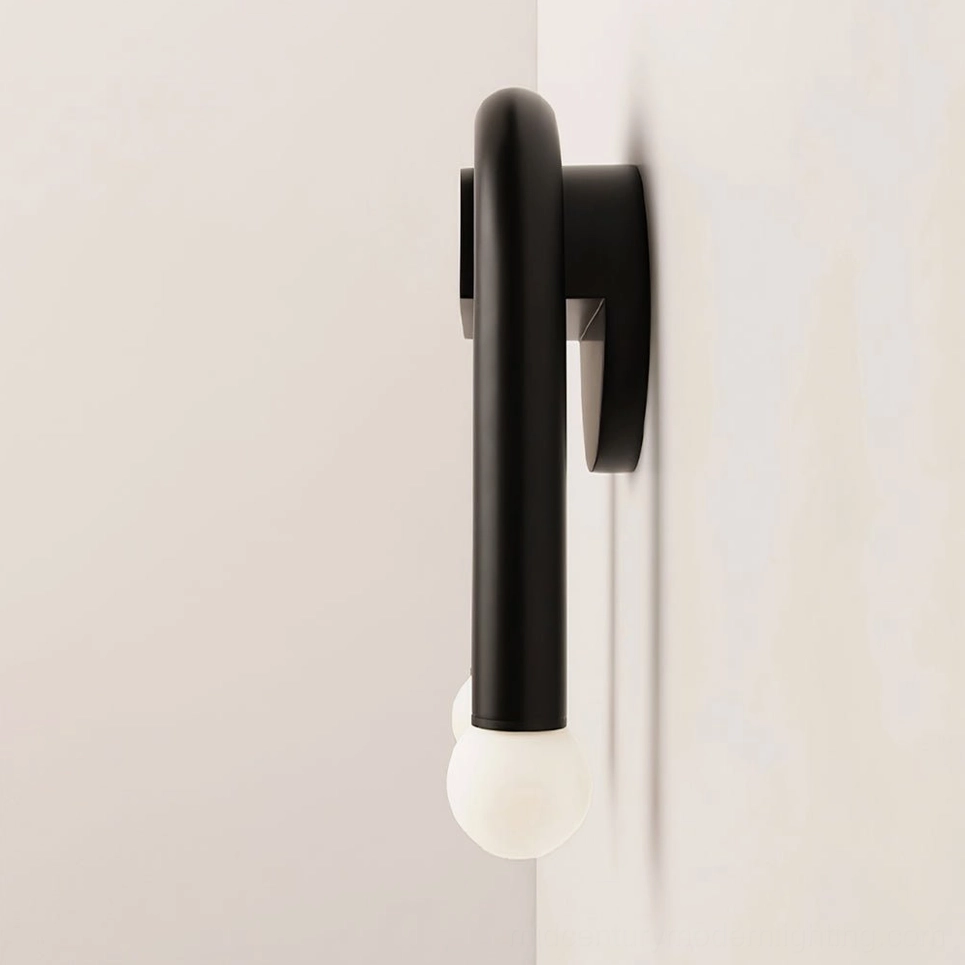 Mid-century modern arched sconce installation detail with dual globe bulbs and geometric metal frame