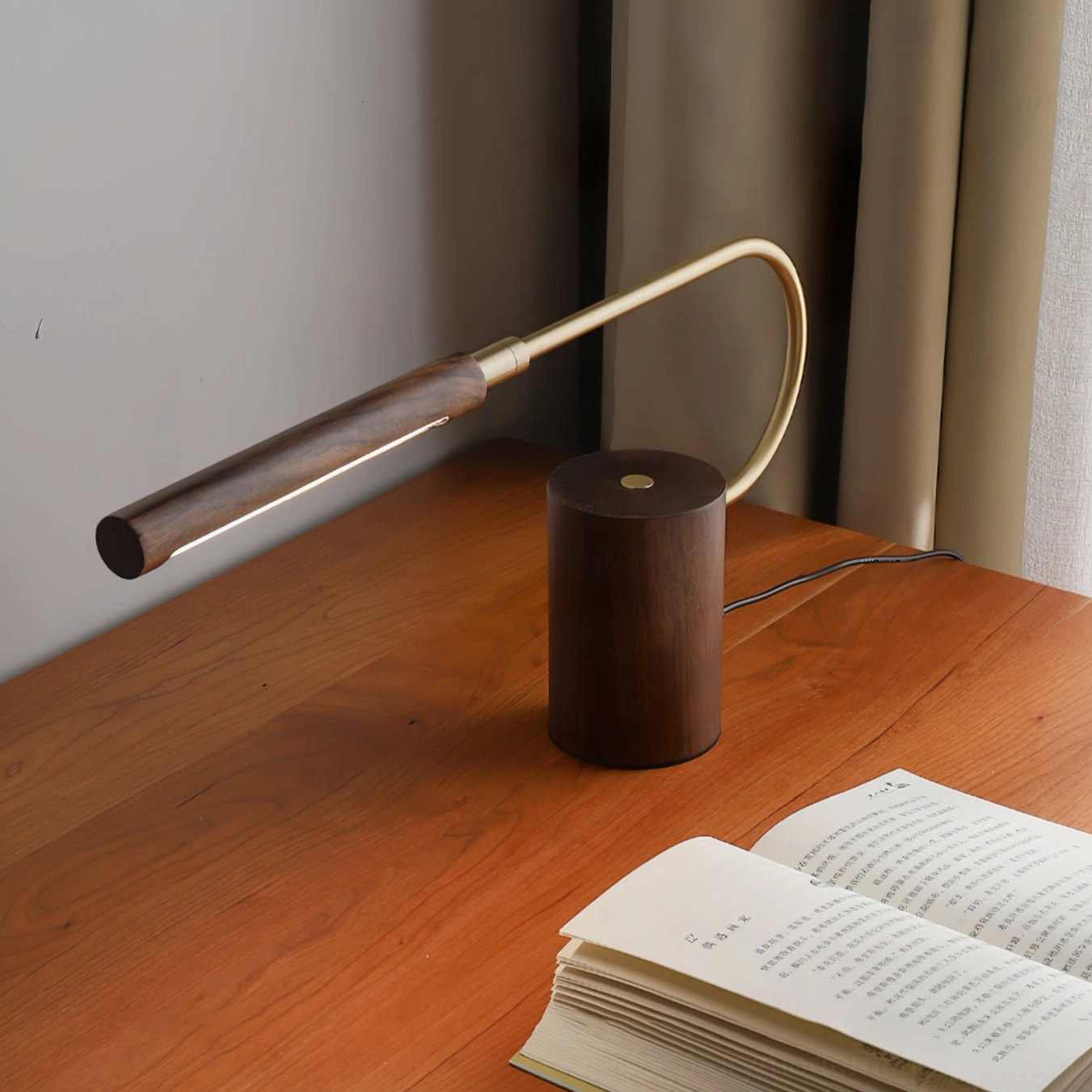 Mid-century modern desk lamp positioned beside open book on wooden study table