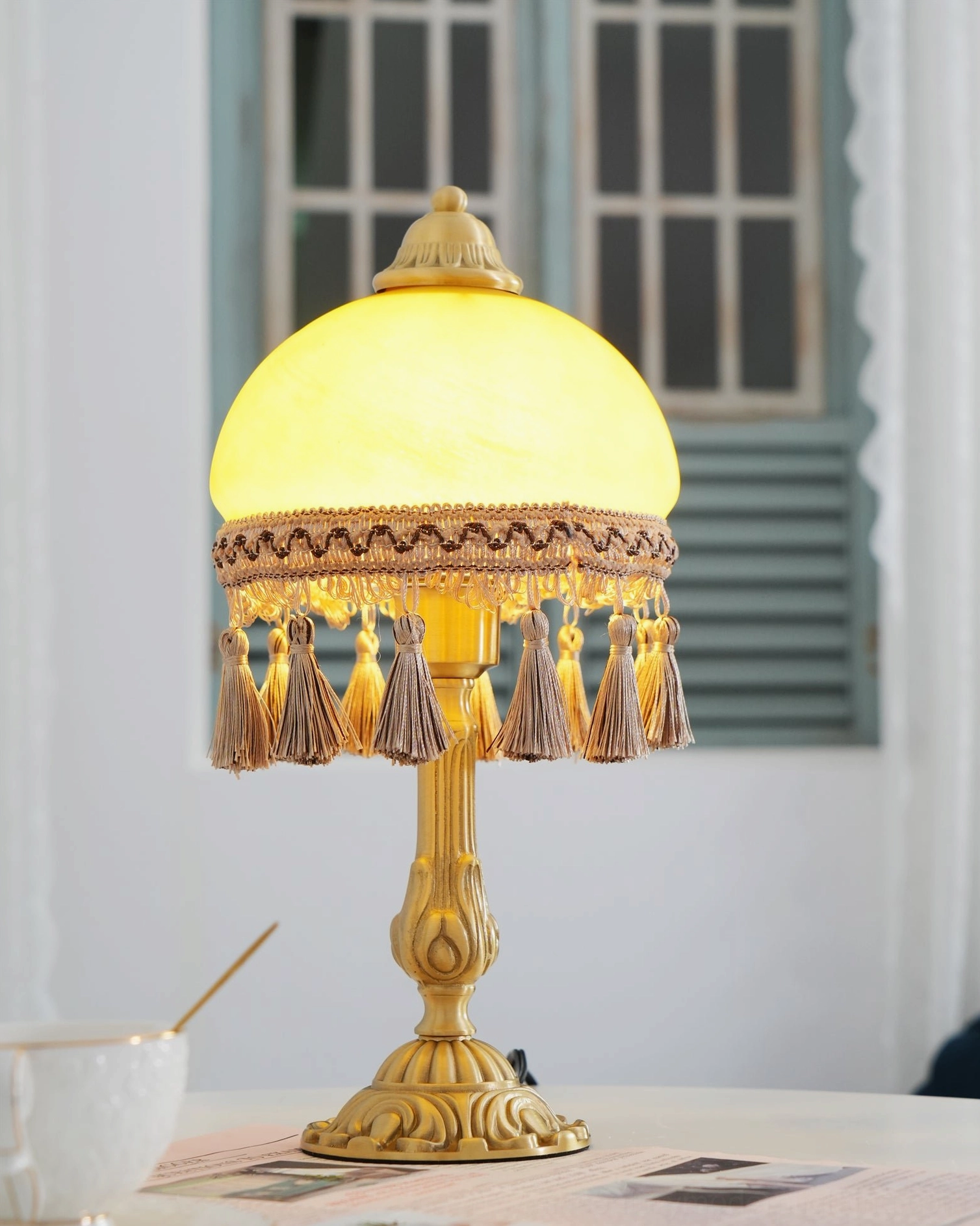 Mid-century brass table lamp illuminated showing warm ambient light and design elegance