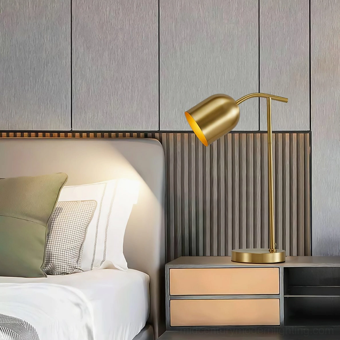 Mid-century modern brass gooseneck lamp with warm ambient light on wooden bedside cabinet with wood-paneled accent wall