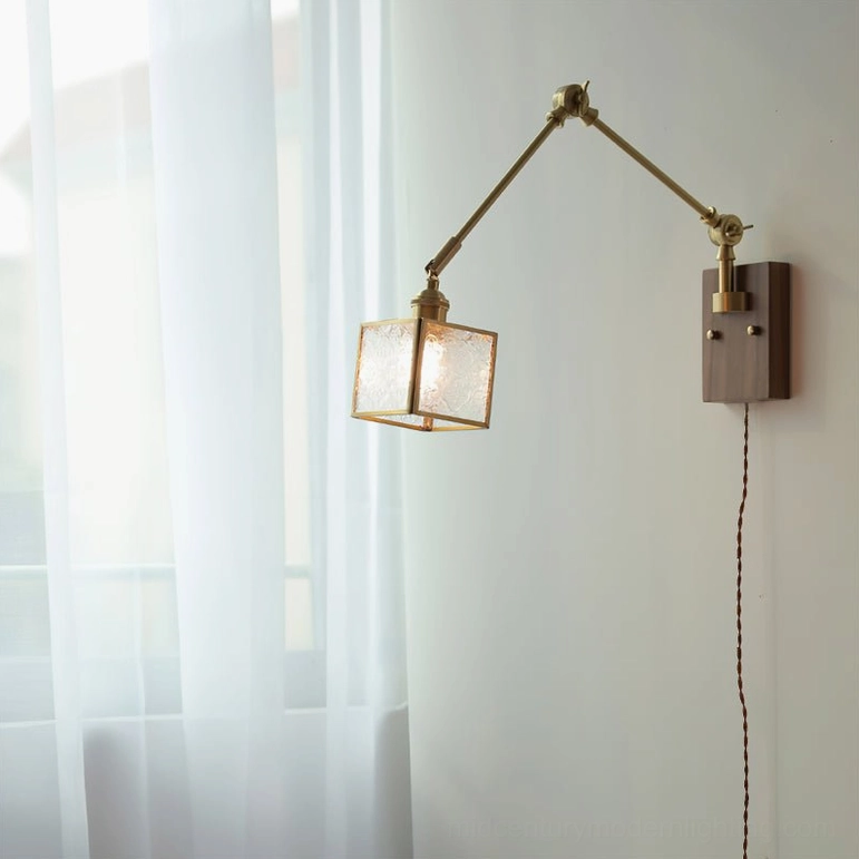 Brass and dark wood swing arm wall lamp front view with ribbed glass shade in contemporary indoor setting