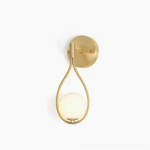 Modern brass vanity wall sconce with frosted glass globe and curved brass arm, front view on white background
