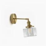 Mid-century modern brass glass wall lamp with square rippled shade, front close-up view