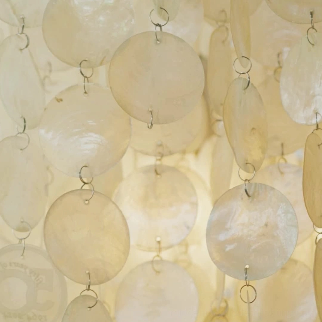 Mid-century modern capiz shell pendant lamp in stylish interior home setting