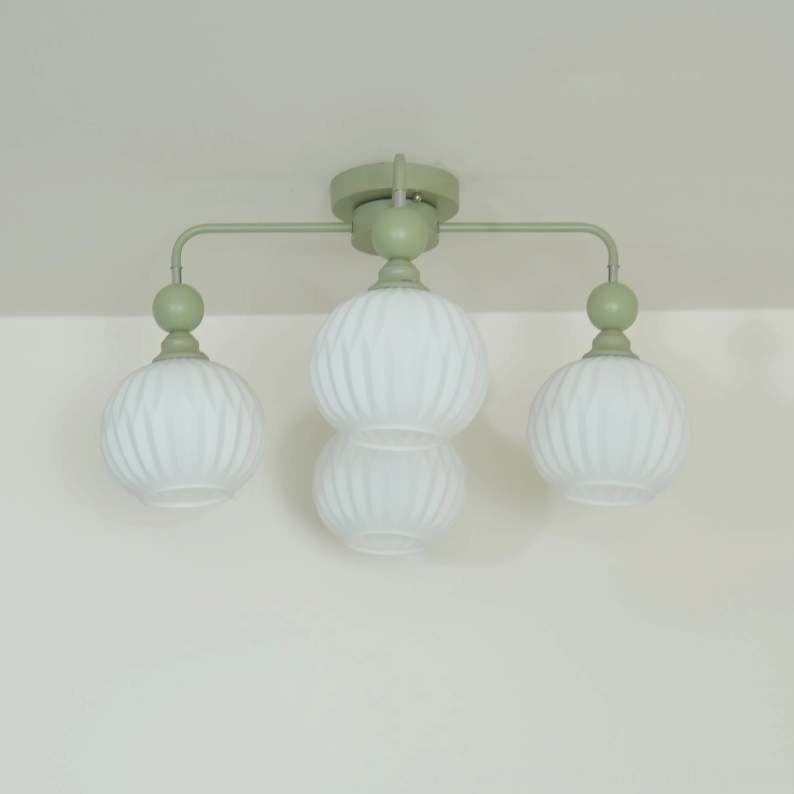 Mid-century modern ceiling chandelier showing metal frame and glass shade assembly
