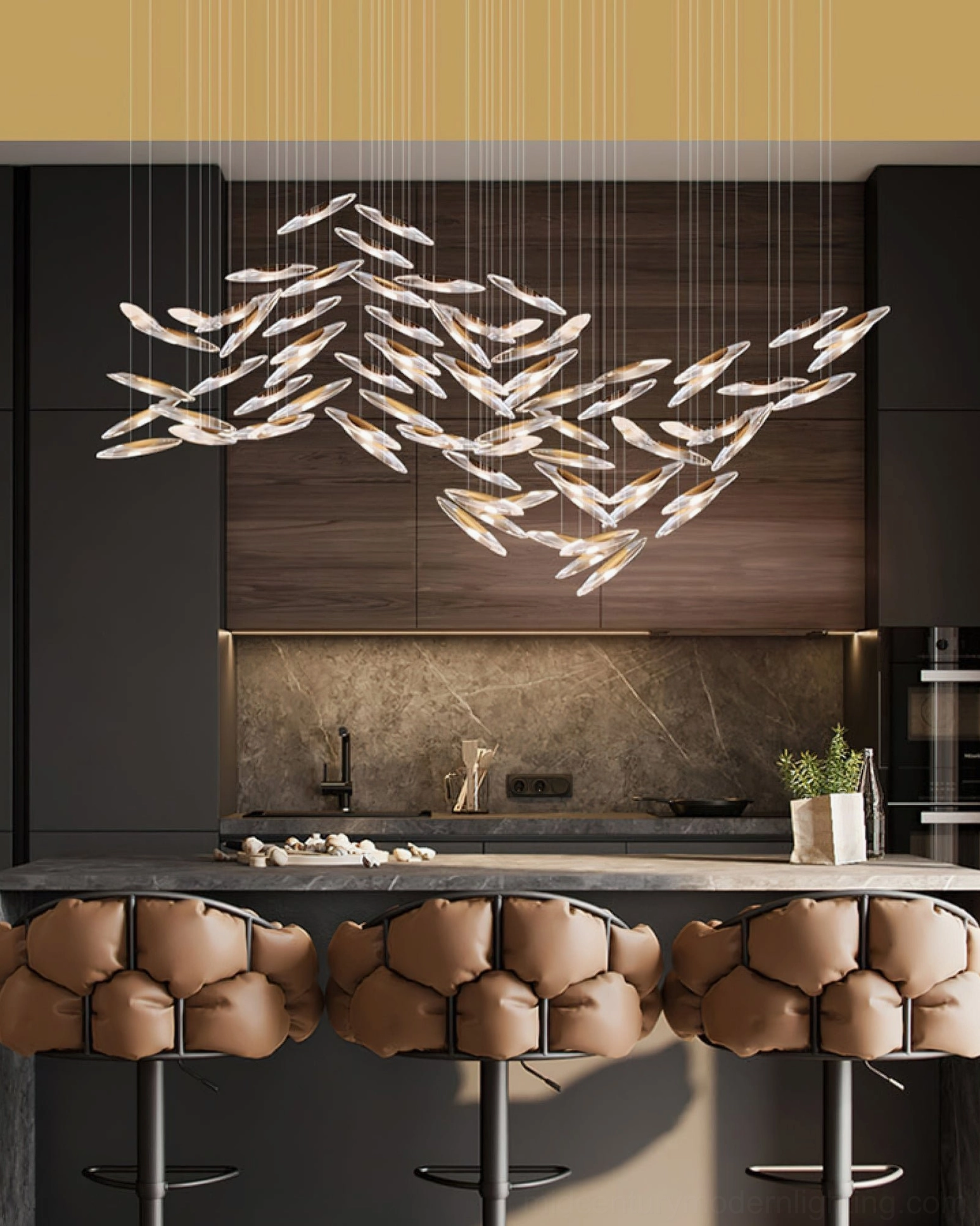 Modern mid-century chandelier with clear glass elements and golden suspension wires in dining setting
