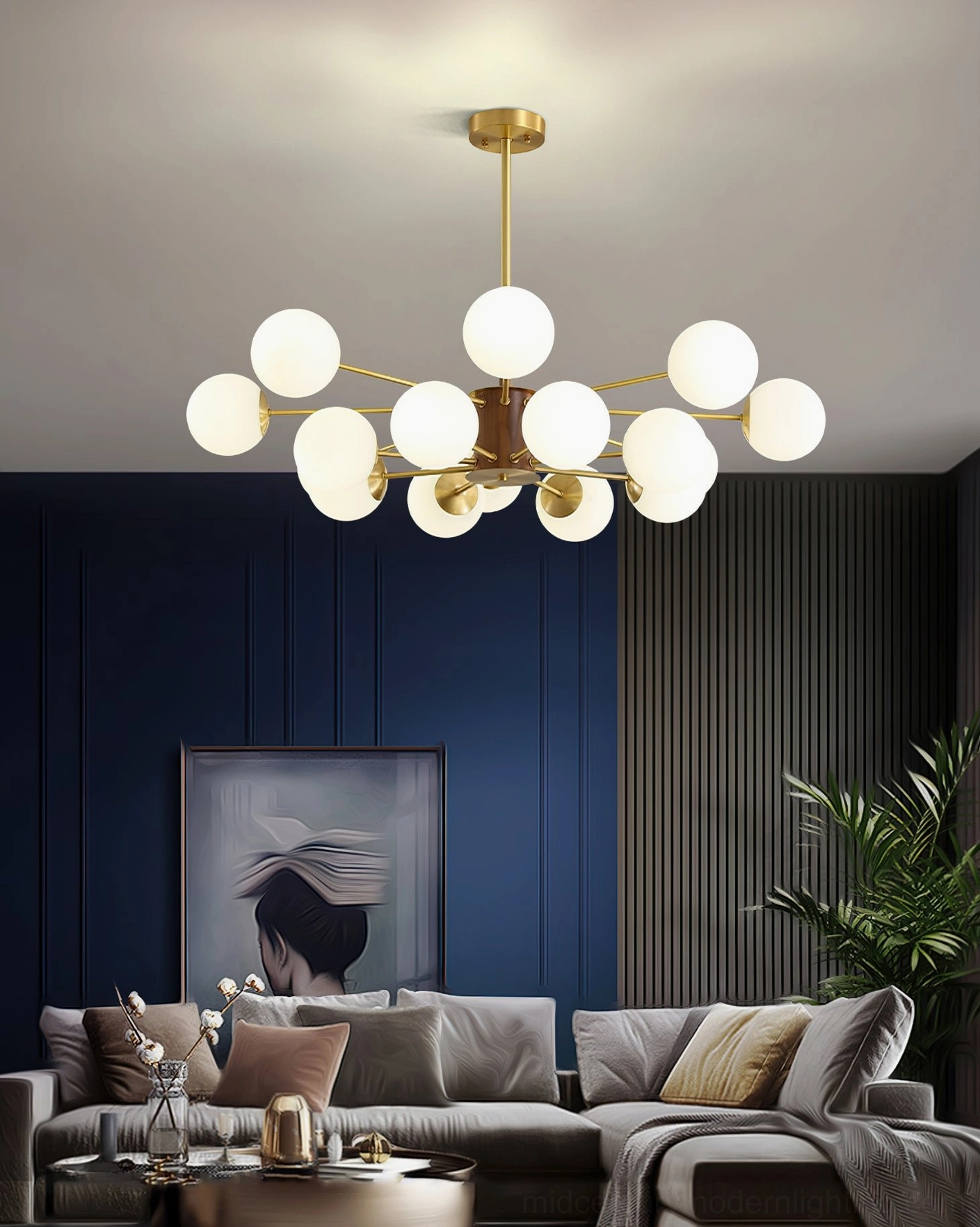 Mid-century modern brass chandelier in luxury living room with blue walls, art, and plants