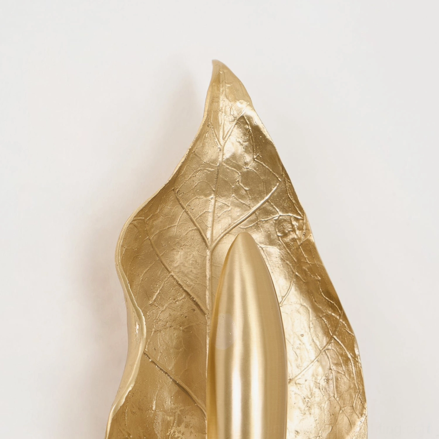 Dumaine mid-century modern brass wall sconce showing minimalist design aesthetic and sculptural leaf form