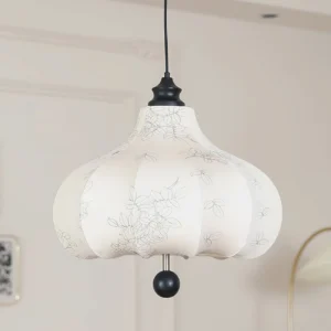 Modern fabric pendant light three-quarter view showing black spherical ornament and ceiling hardware