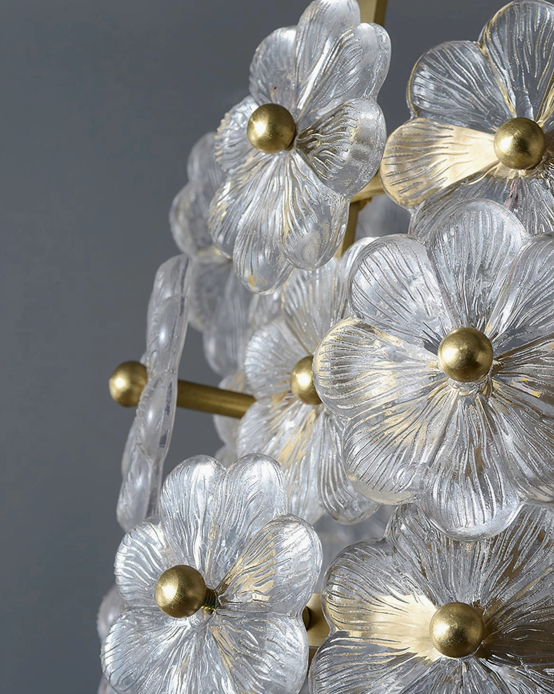 Mid-century modern glass flower pendant illuminated from beneath showing internal light diffusion through glass