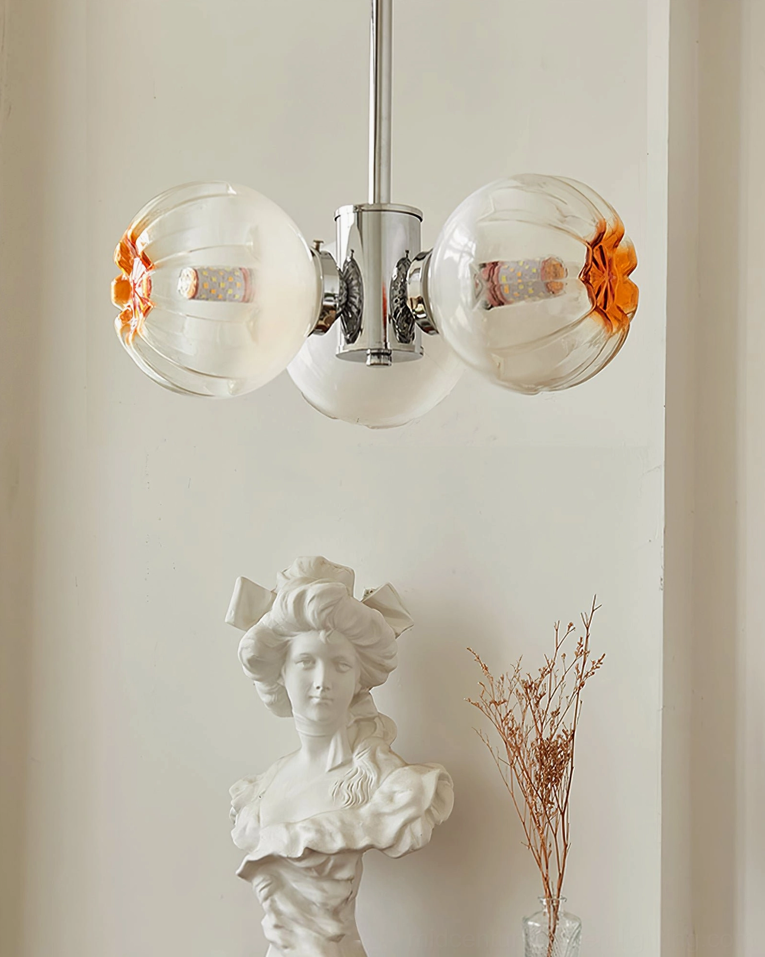 Mid-century modern Flower Bud Chandelier with polished chrome and amber glass in vintage interior design setting