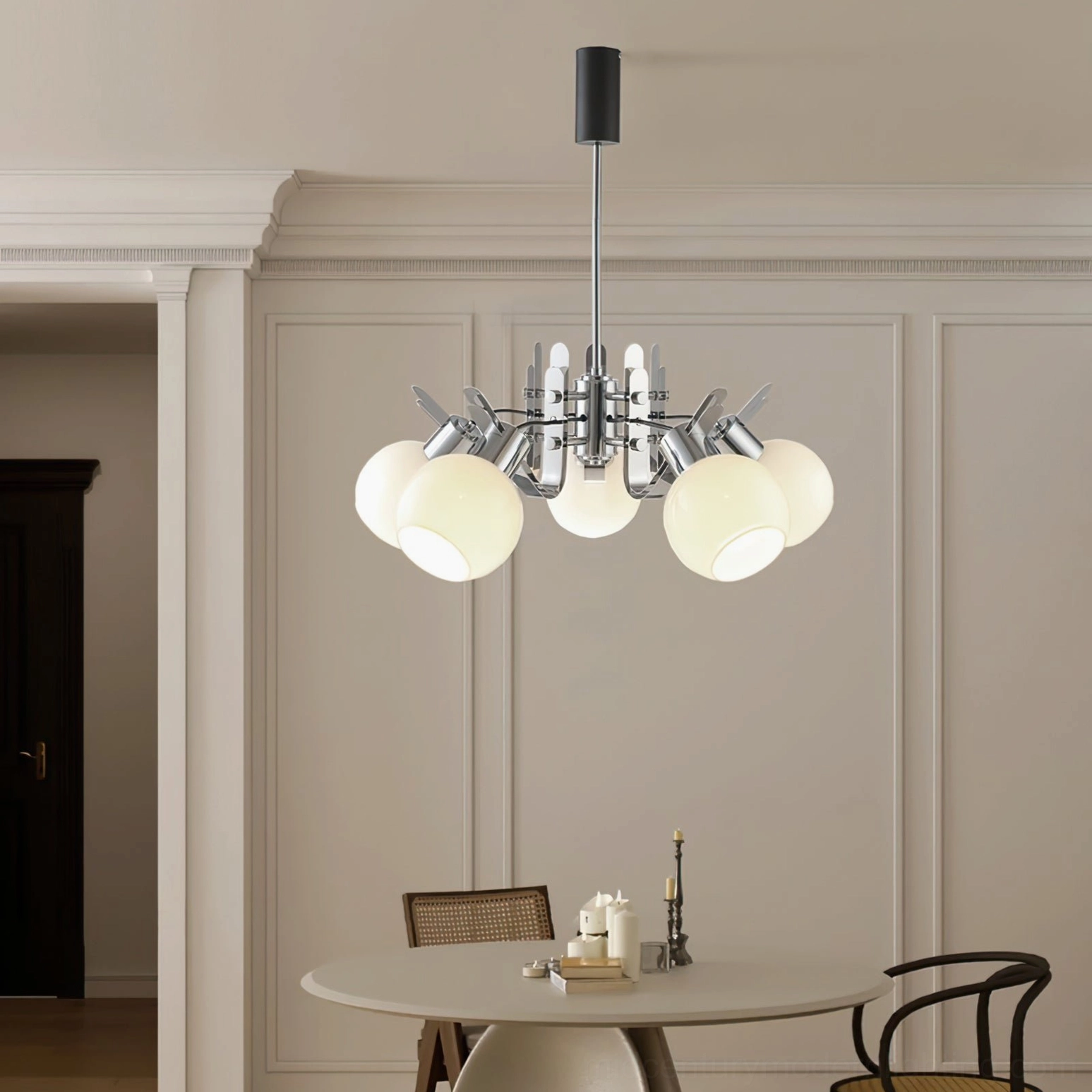 Mid-century modern geometric glass pendant light with translucent opal shades over dining area