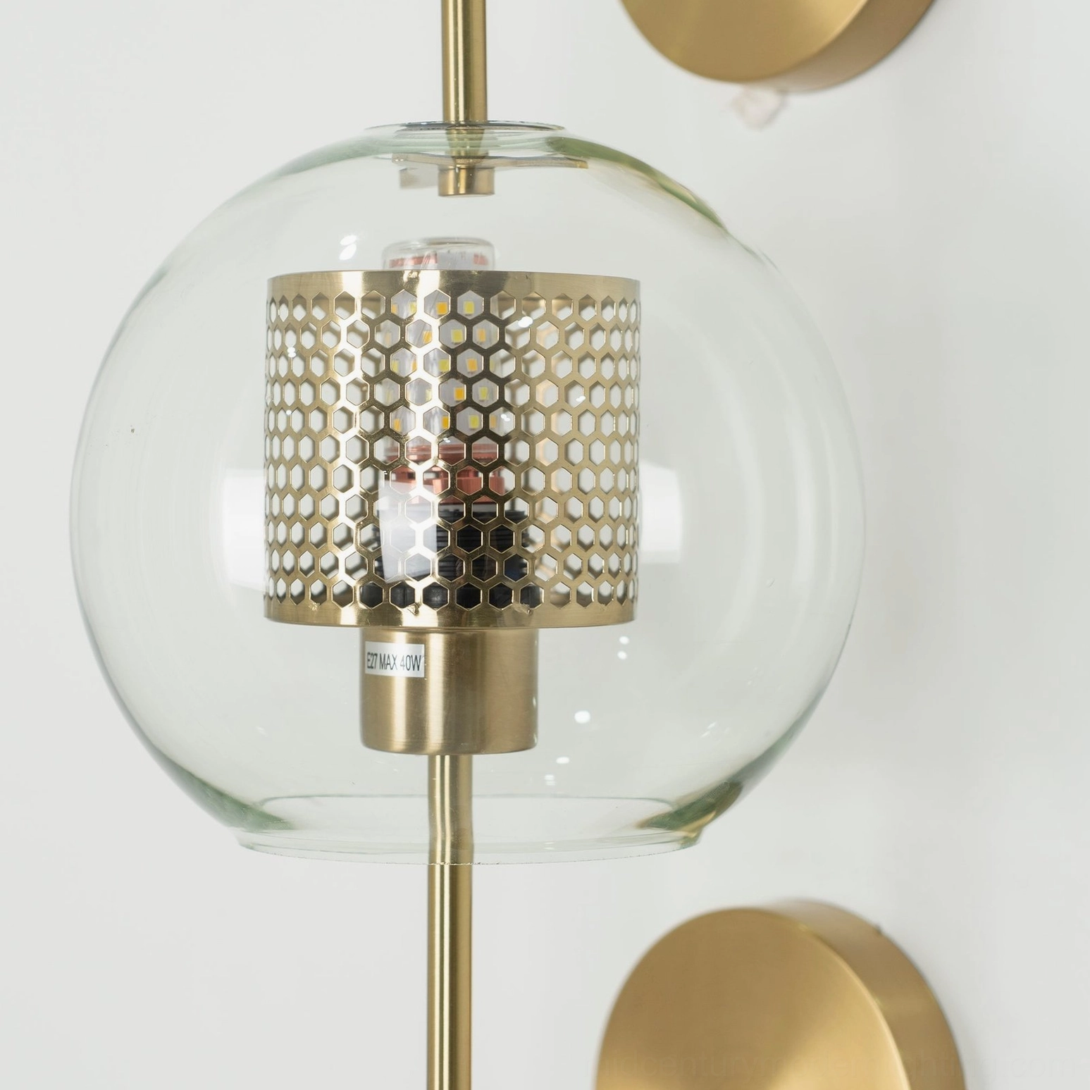 Mid-century modern glass wall lamp with brass fittings and clean geometric form