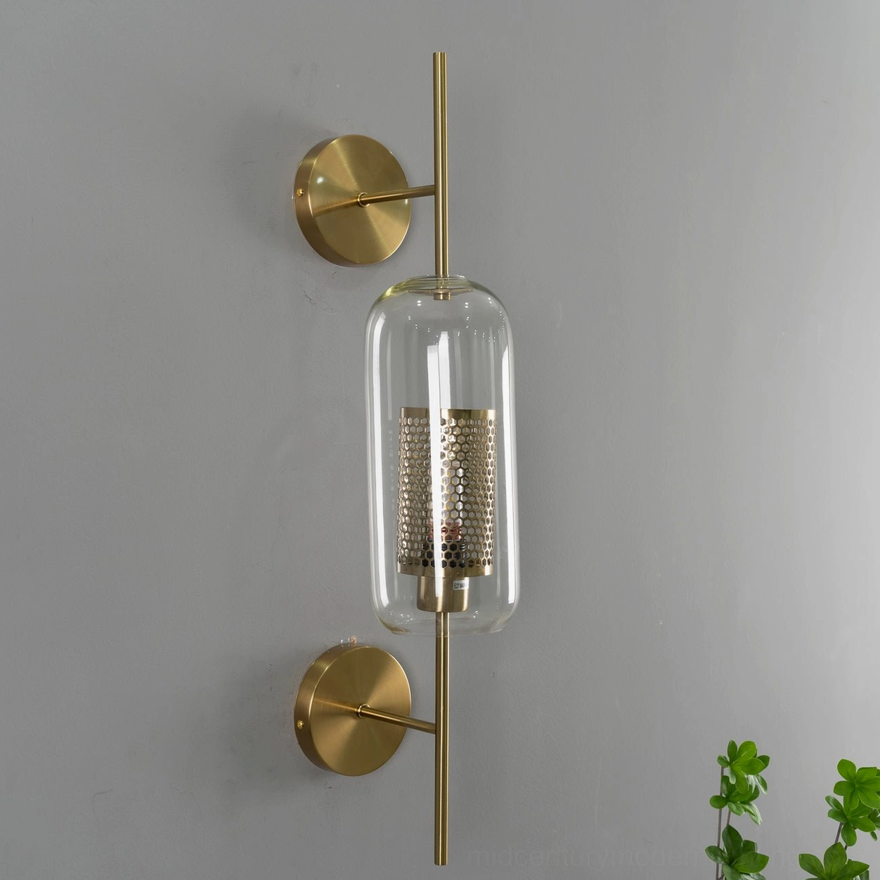 Modern mid-century glass wall sconce with minimalist brass hardware