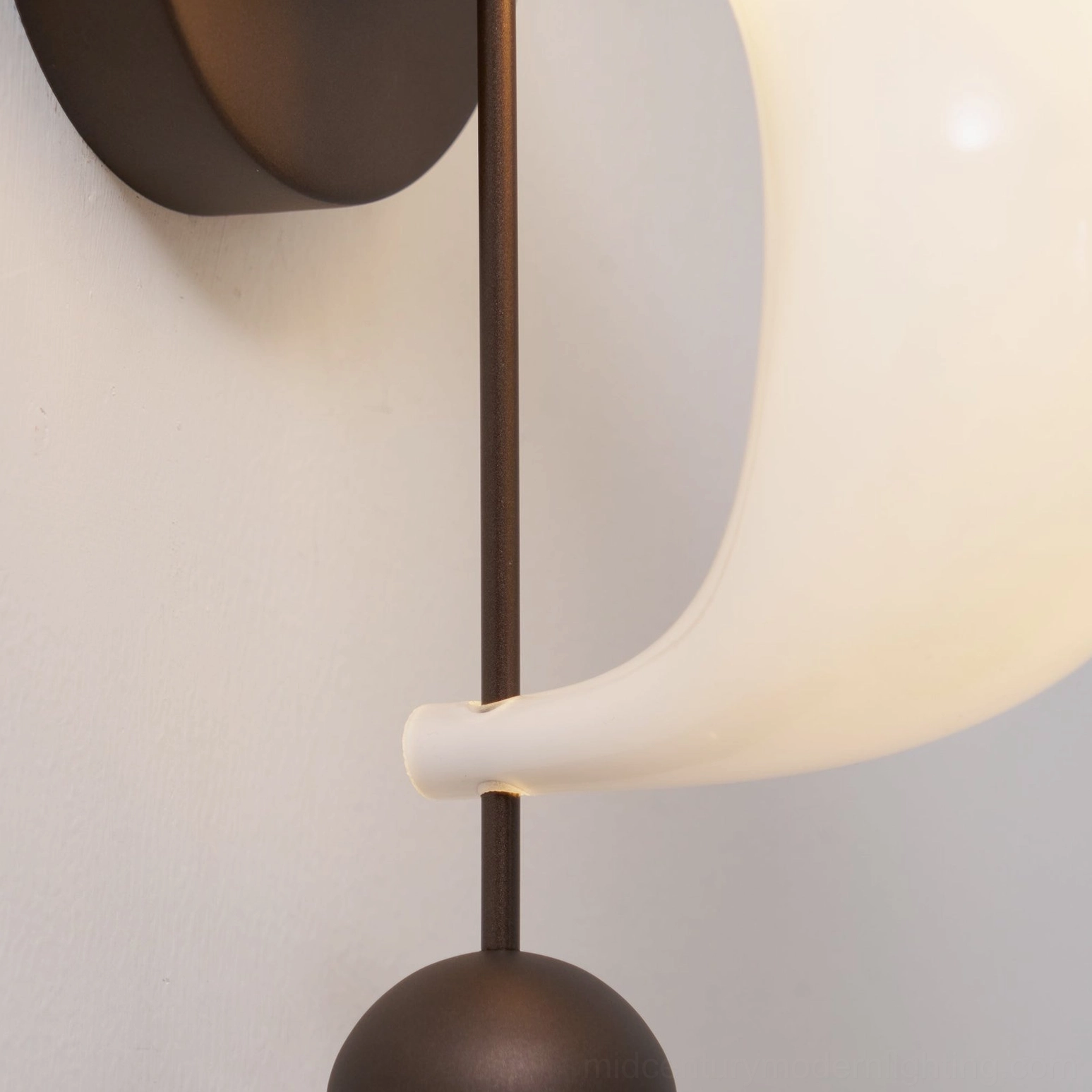 Mid-century modern glass wall sconce with three spherical pendants and curved shade, statement piece for gallery walls