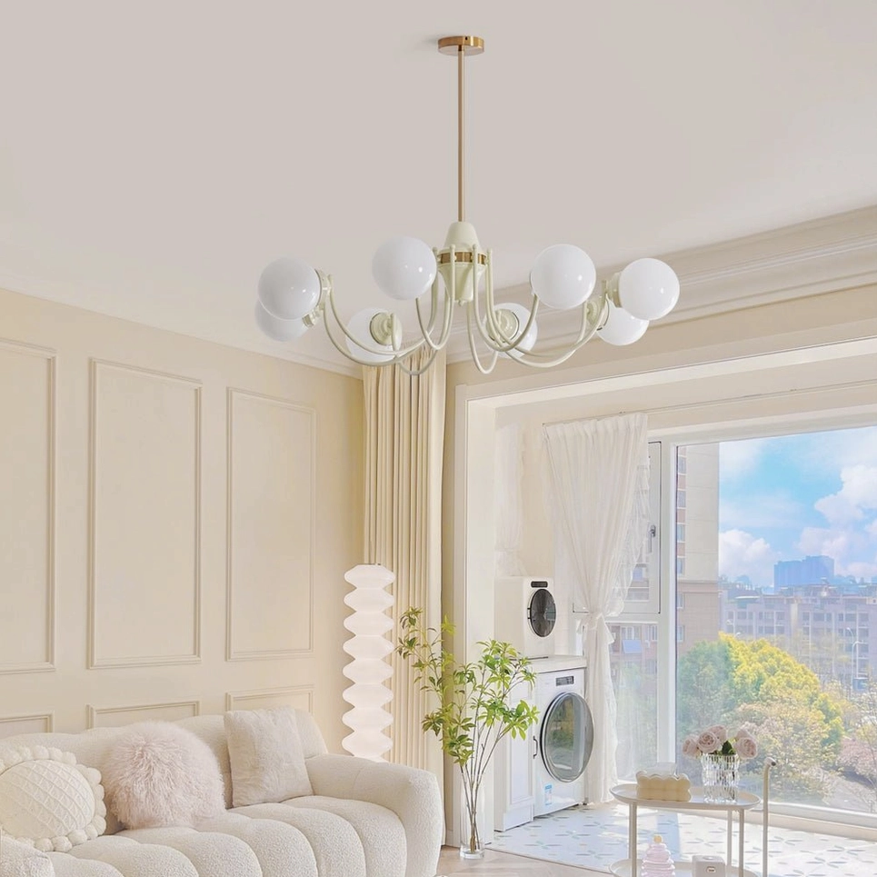 Modern globe chandelier with spherical glass shades installed in contemporary French cream living room