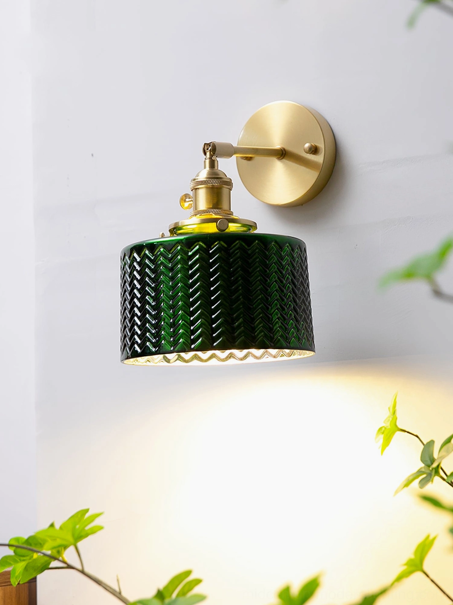 Mid-century modern green glass wall sconce with clear view of chevron textured cylindrical shade